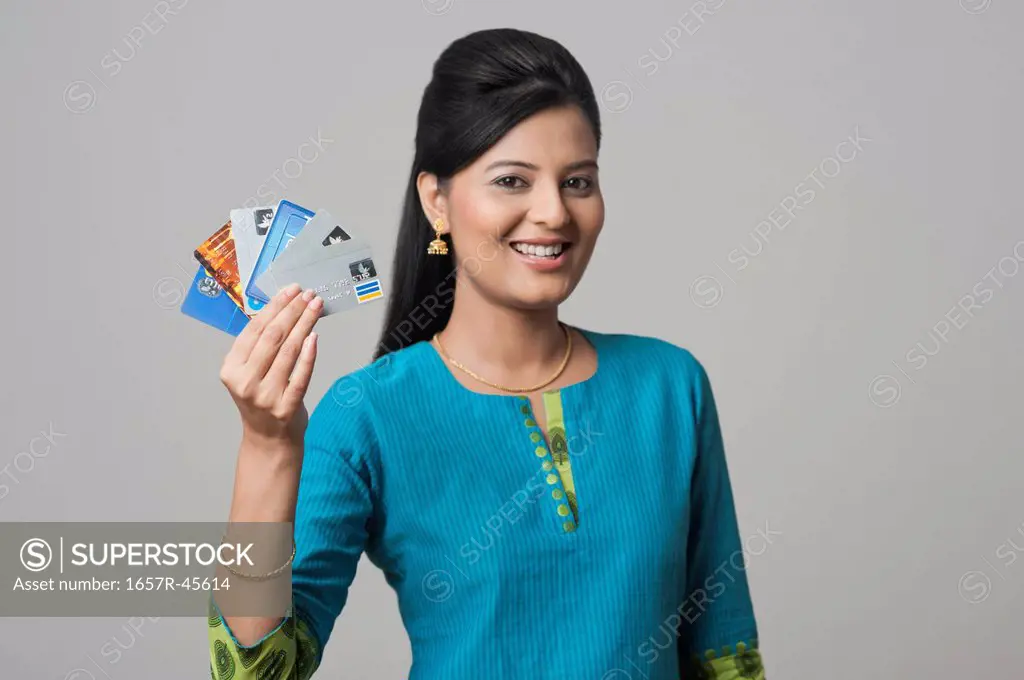Woman showing credit cards and smiling