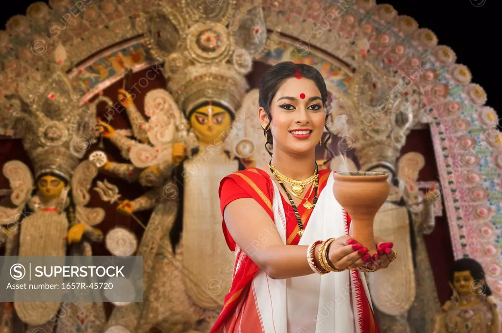 Bengali woman performing Dhunachi Dance at Durga Puja