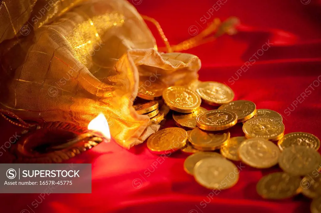 Diwali oil lamp with golden coins during Diwali festival