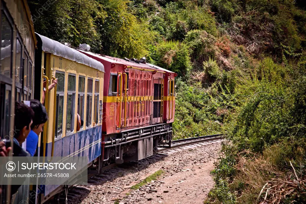 Train moving on railroad track in valley, Shimla, Himachal Pradesh, India