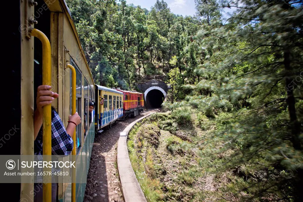Train moving on railroad track in valley, Shimla, Himachal Pradesh, India