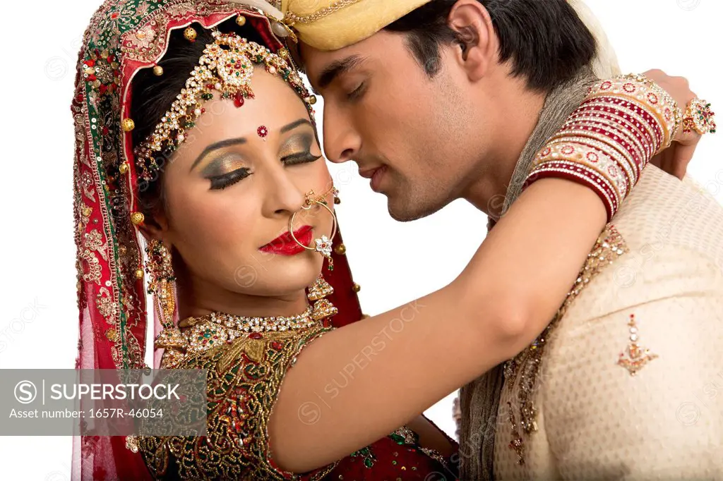 Close-up of an Indian newlywed couple romancing