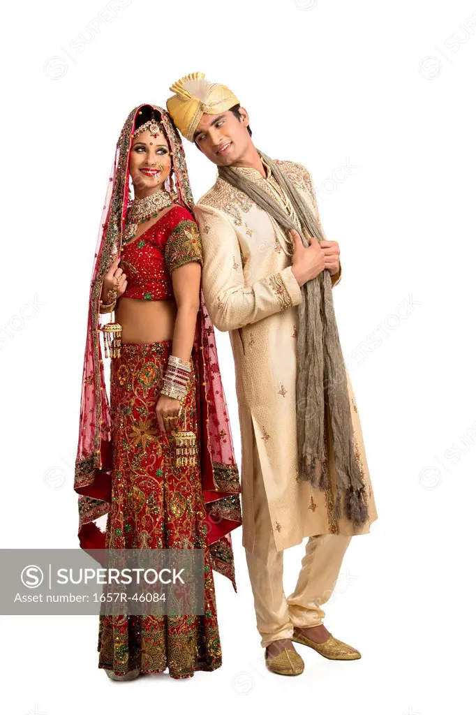 Smiling Indian newlywed couple posing