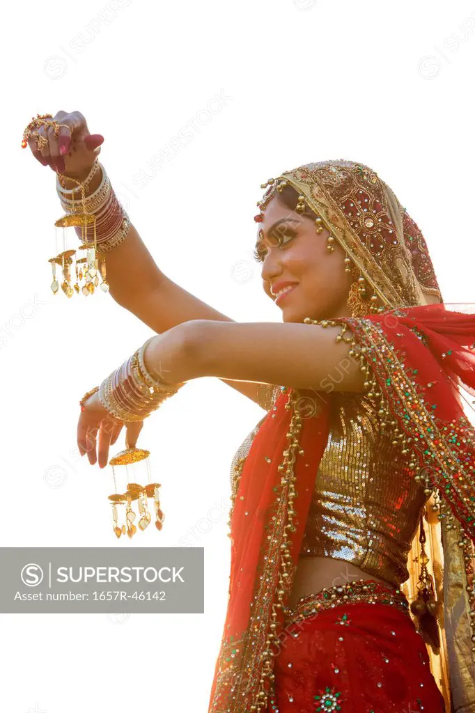 Indian bride in traditional wedding dress and posing