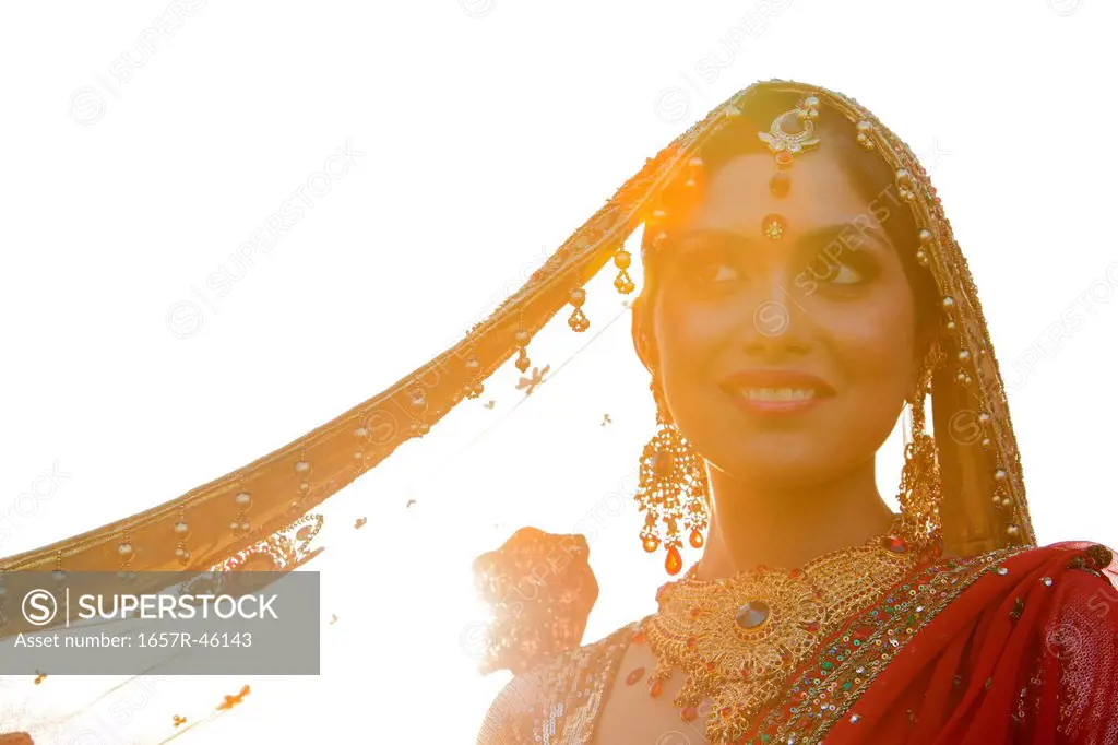Indian bride in traditional wedding dress and posing