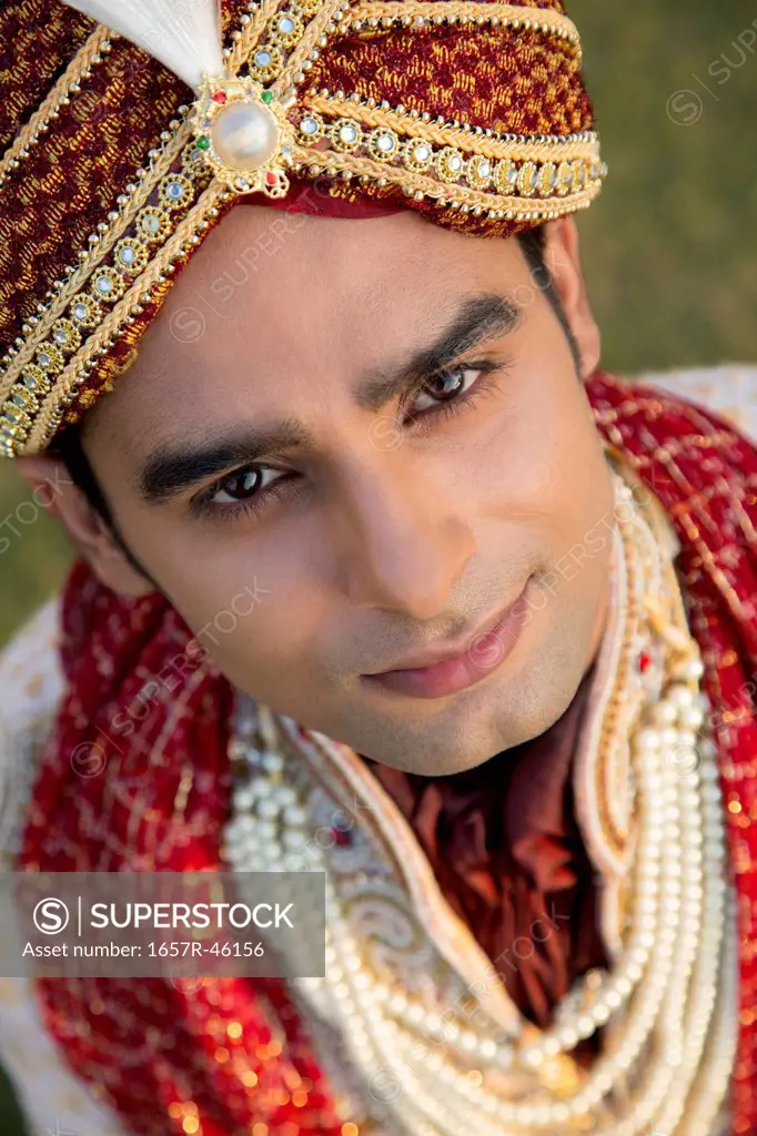 Portrait of an Indian groom in traditional wedding outfit