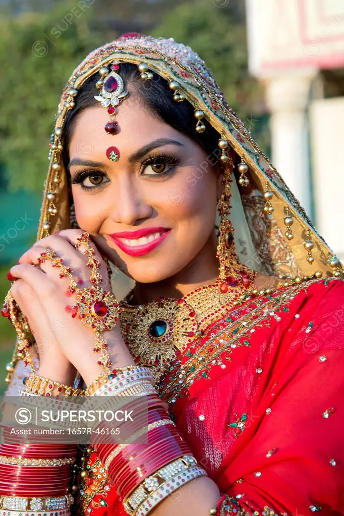 Beautiful Indian bride in traditional wedding dress and posing