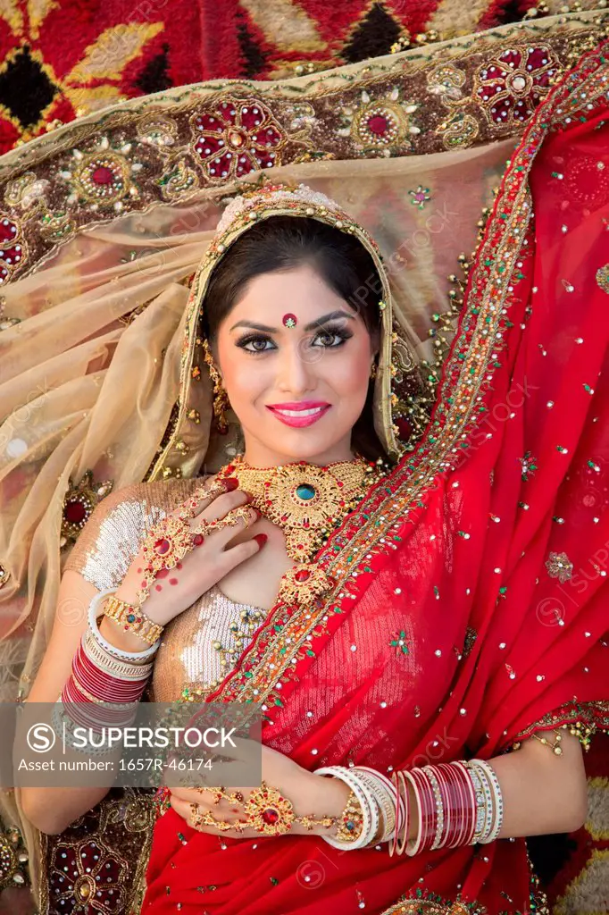 Beautiful Indian bride in traditional wedding dress and posing