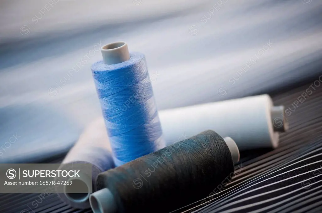 Close-up of spools of thread on a fabric