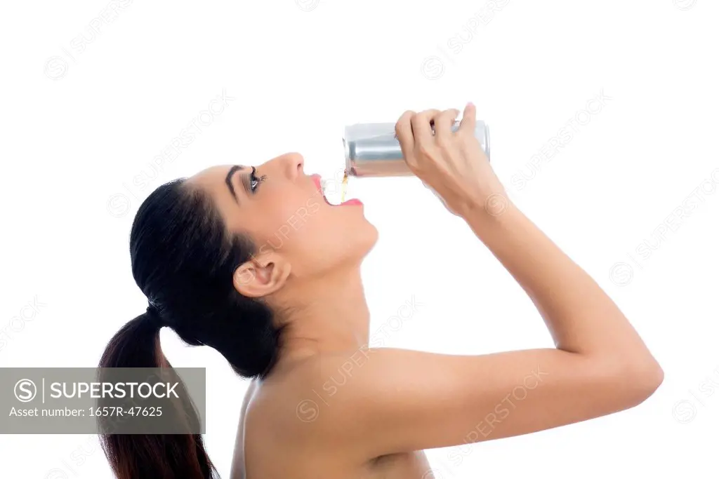 Side profile of a woman drinking soft drink