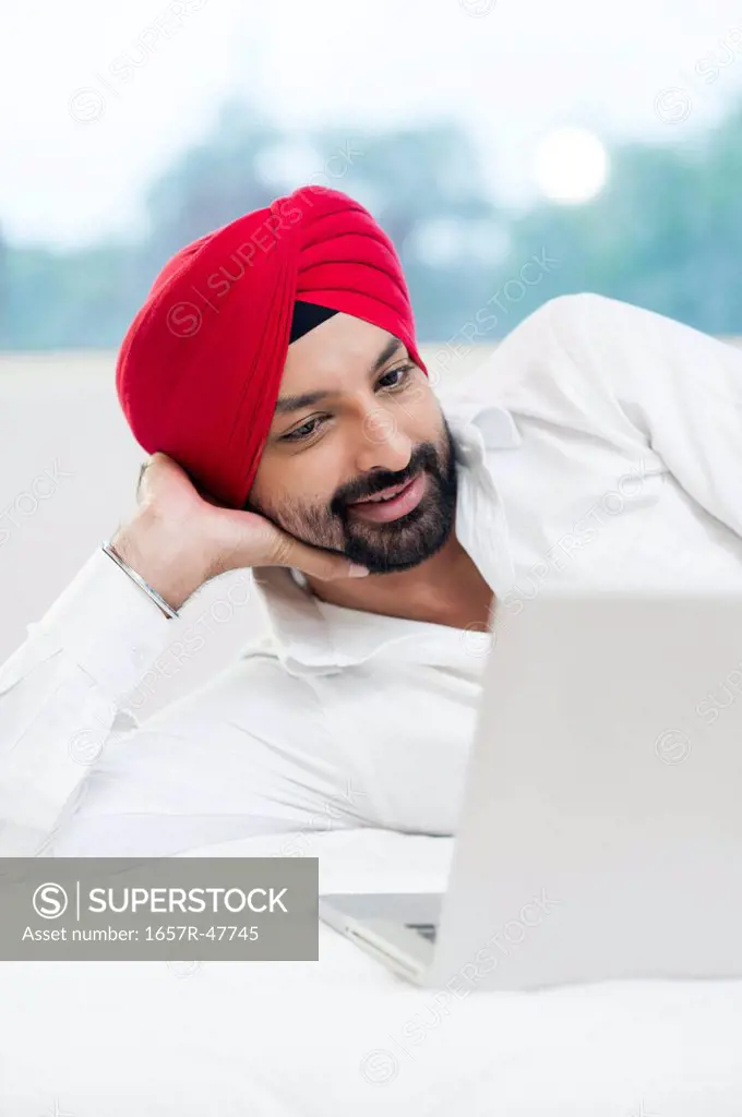 Sikh man using a laptop