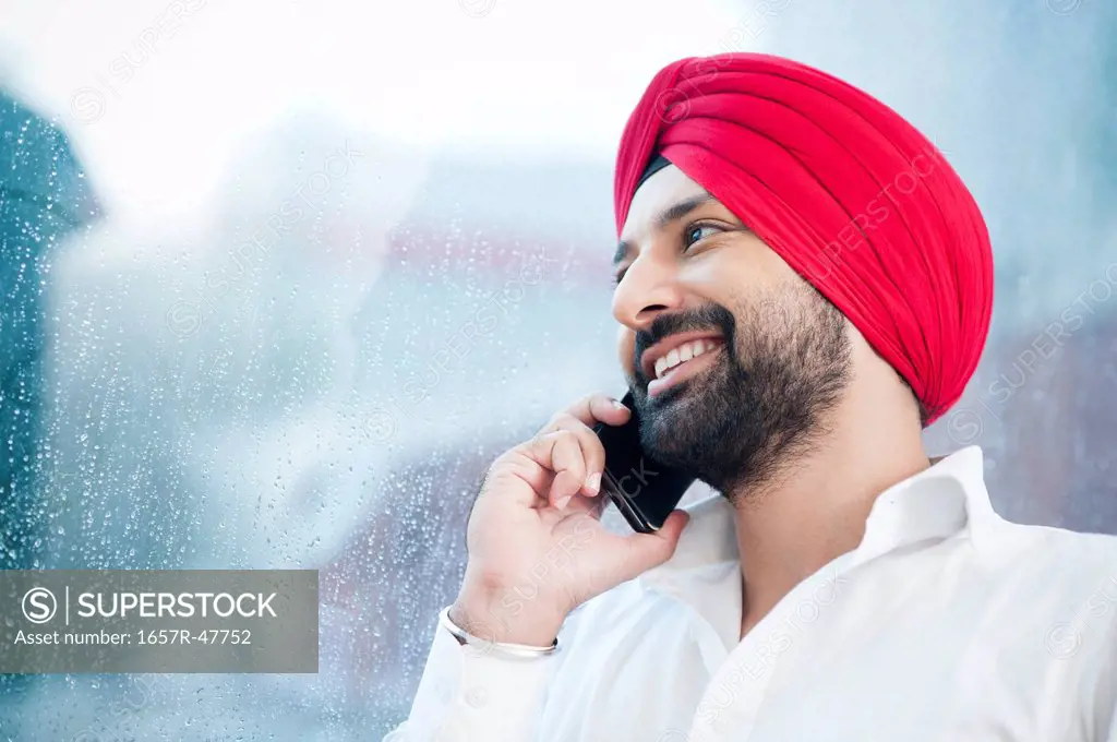 Close-up of a Sikh man talking on a mobile phone
