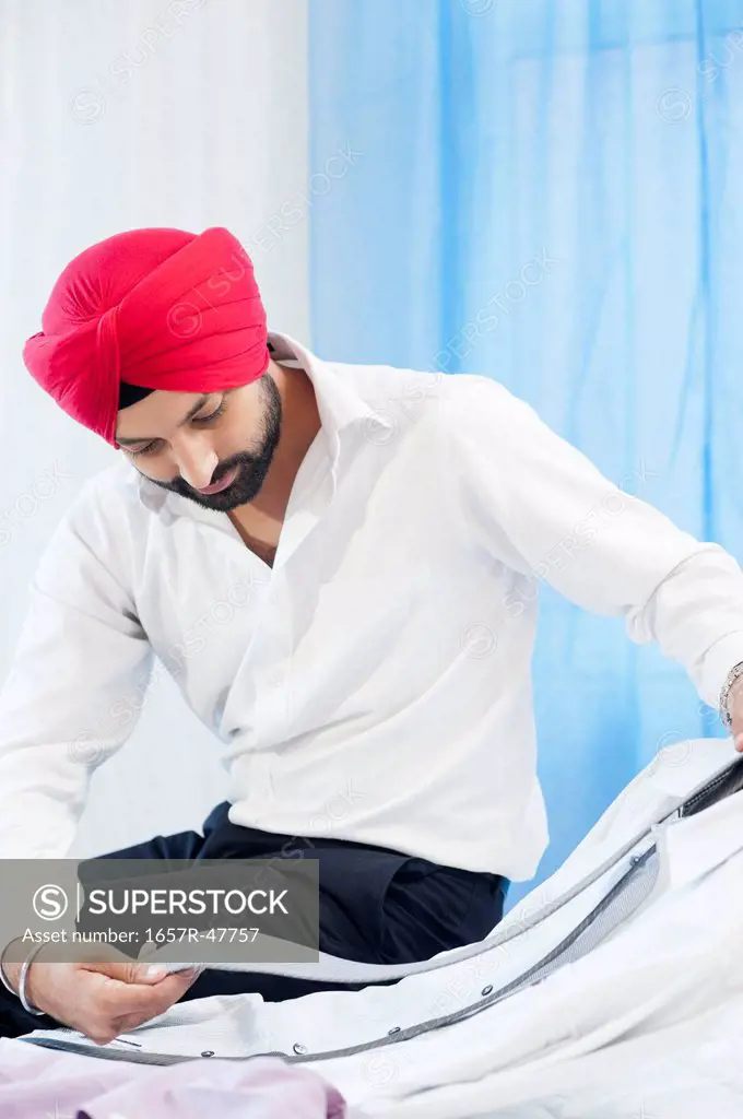 Sikh man matching a tie with his suit
