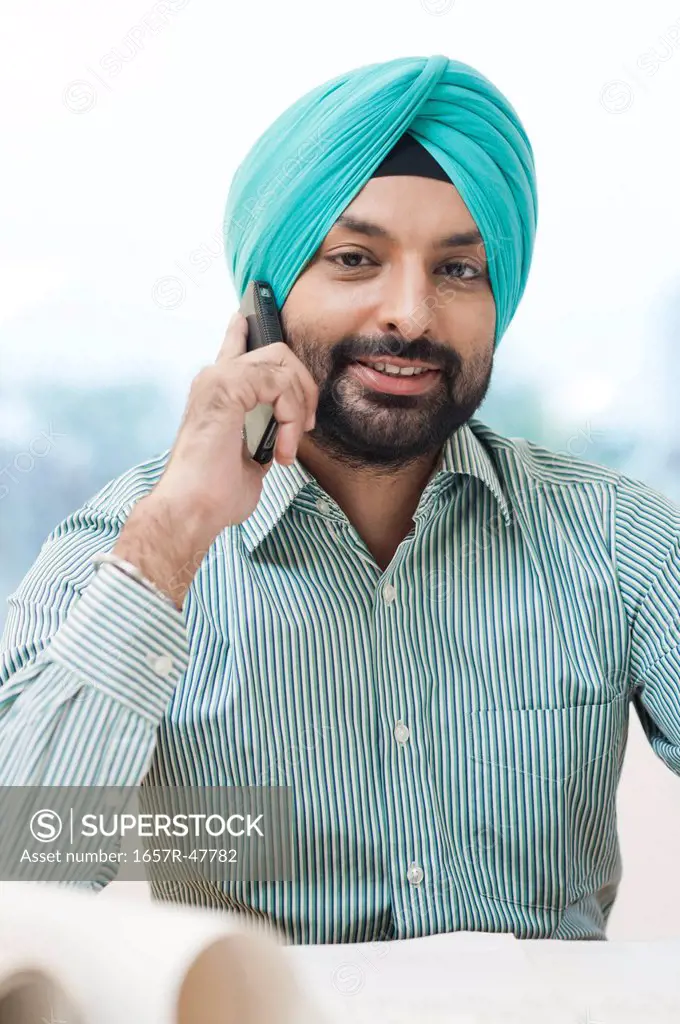 Portrait of a Sikh man talking on a mobile phone