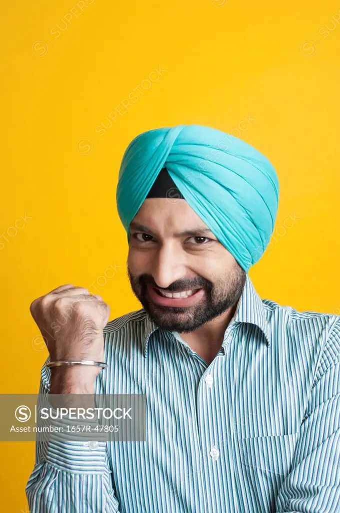 Portrait of a Sikh man clenching his fist
