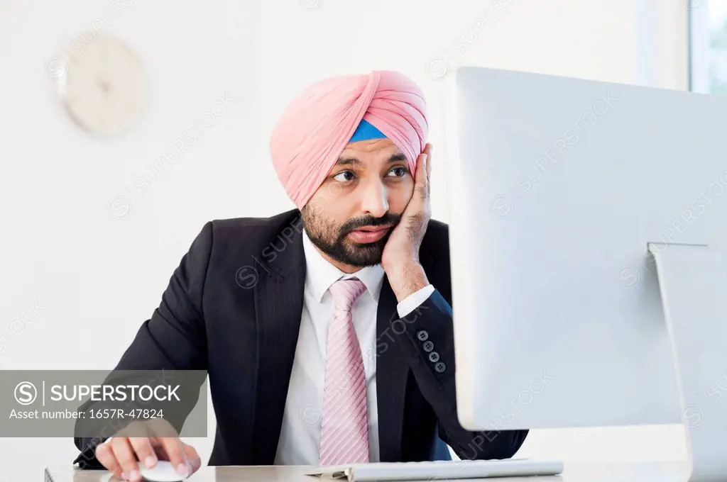 Businessman working on a computer and thinking