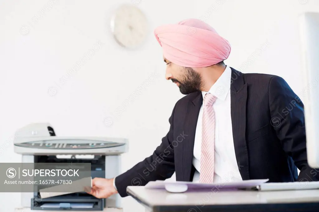 Businessman taking printout of a document