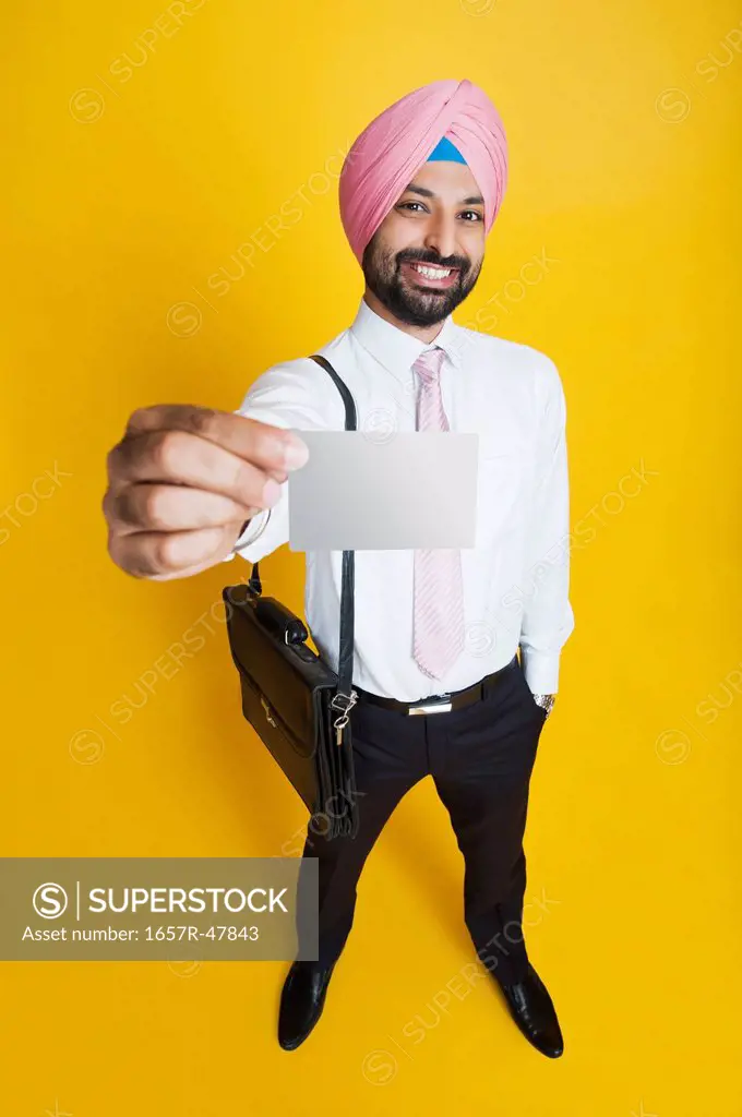 Businessman showing a blank business card and smiling