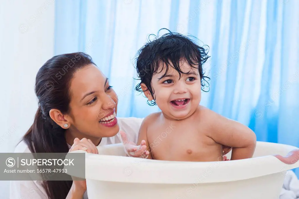 Woman giving bath to her son