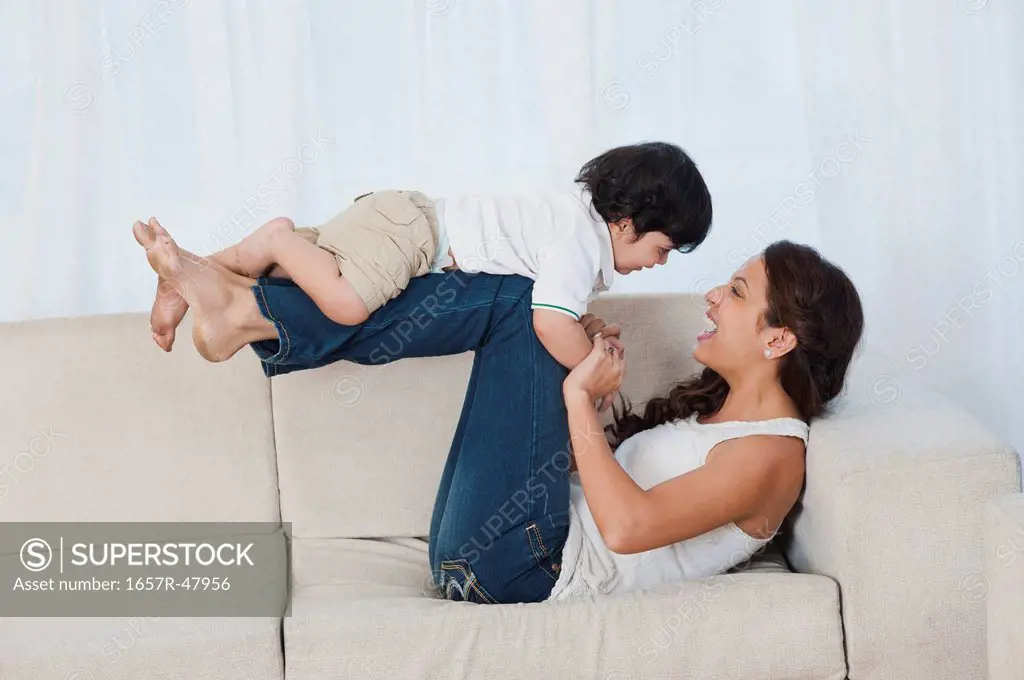 Woman playing with her son on the couch