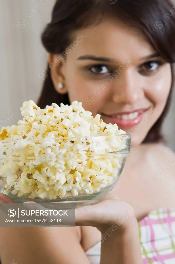 Woman holding popcorns in a bowl
