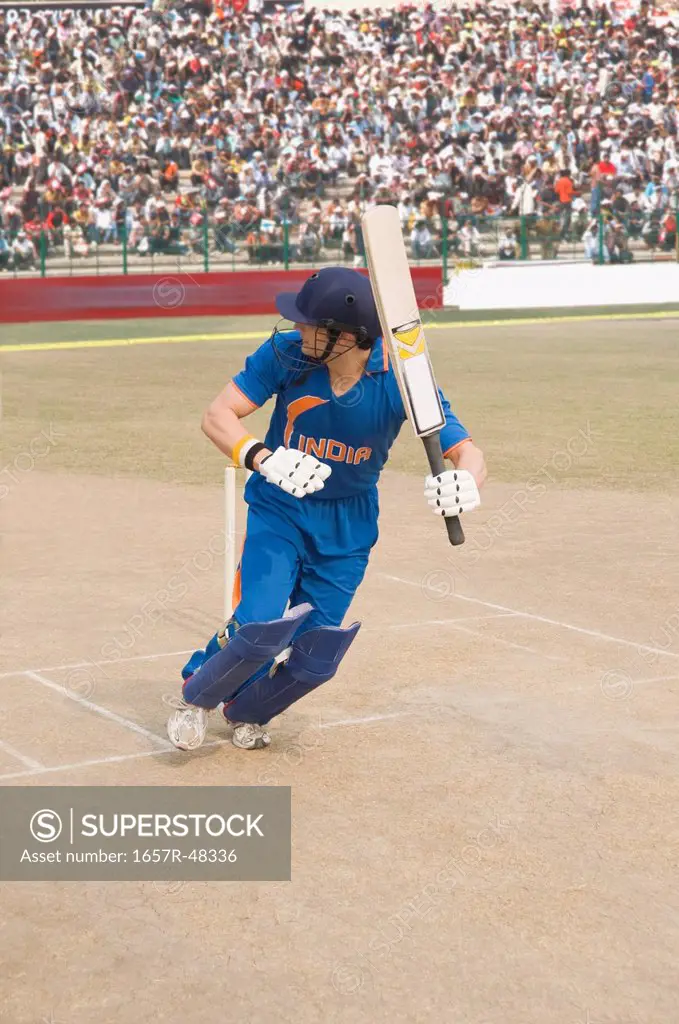 Cricket batsman in running position after playing a shot