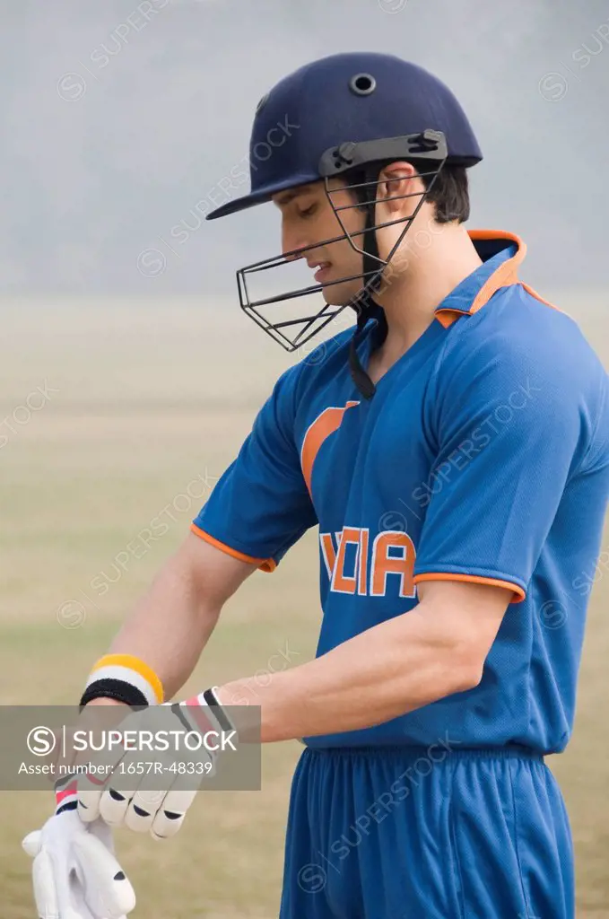 Cricket batsman wearing gloves