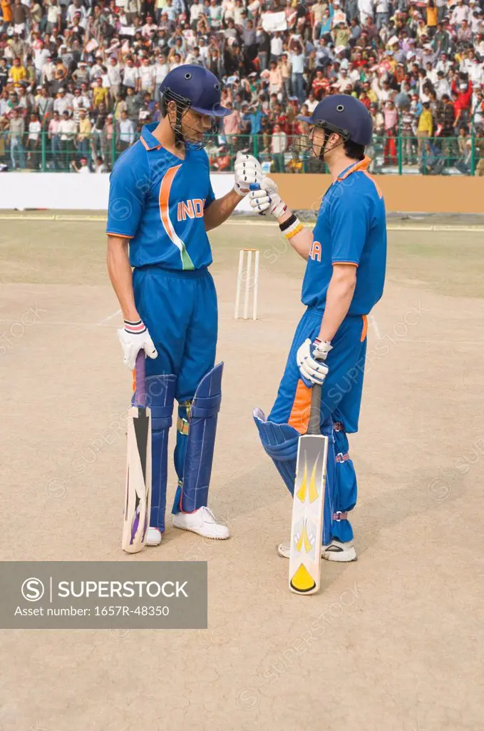 Two cricket batsmen discussing at wicket