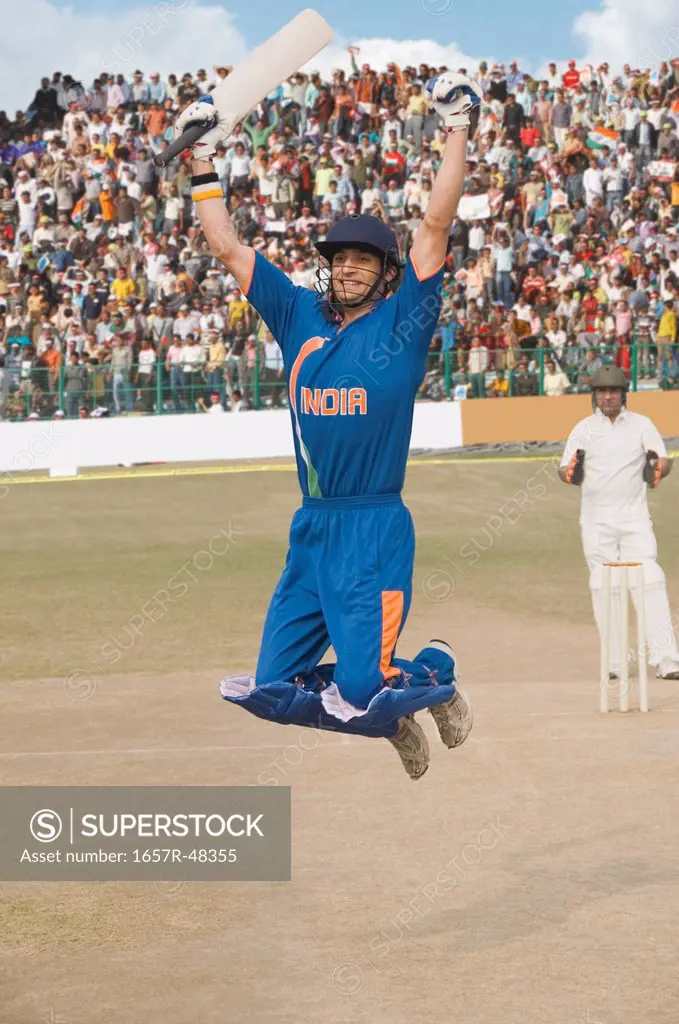 Cricket batsman jumping in excitement
