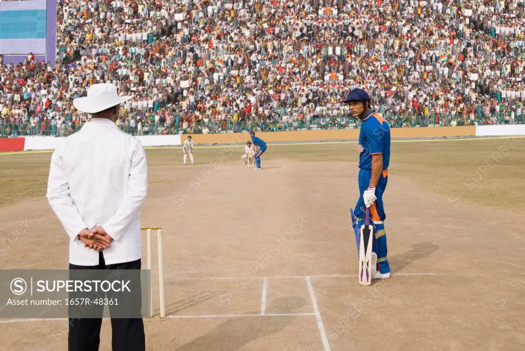 Cricket umpire and a batsman at the field