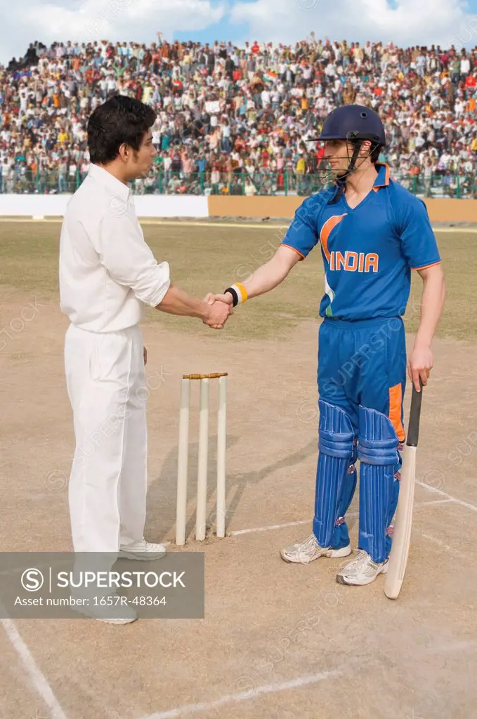 Two cricket players shaking hands