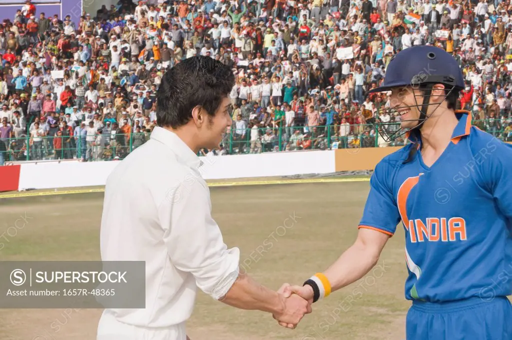 Two cricket players shaking hands