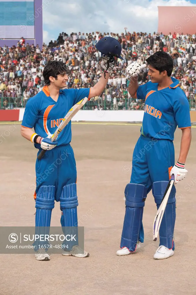 Two cricket batsmen celebrating success