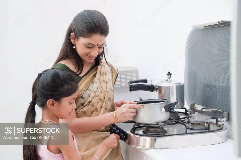 Girl helping her mother in preparing food