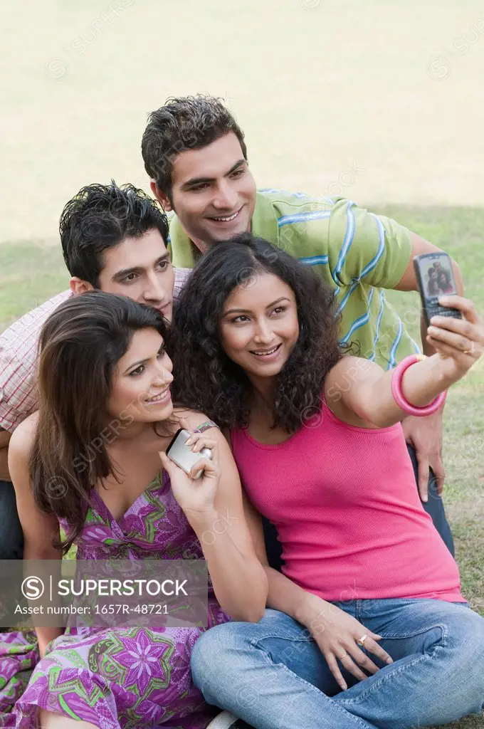Friends taking a picture of themselves with a mobile phone