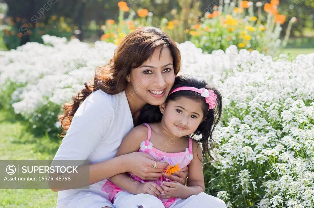 Woman sitting with her daughter and smiling, Gurgaon, Haryana, India