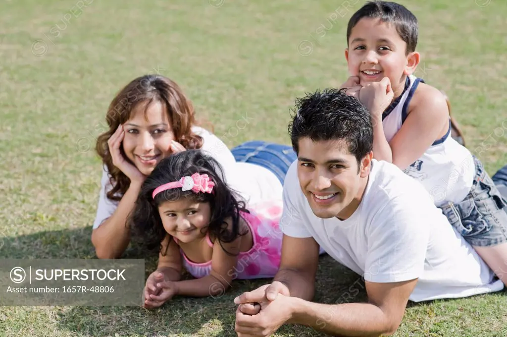 Portrait of a family smiling in a lawn, Gurgaon, Haryana, India