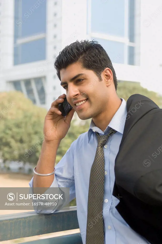 Businessman talking on a mobile phone, Gurgaon, Haryana, India