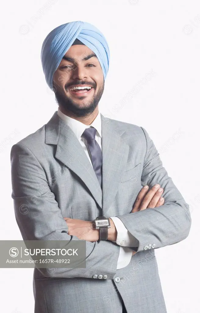 Businessman laughing with arms crossed