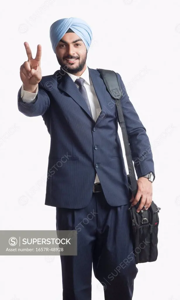 Businessman gesturing victory sign