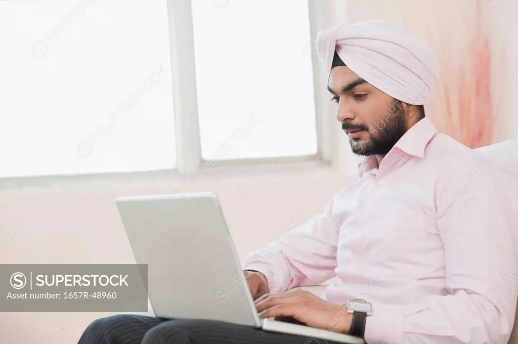 Businessman working on a laptop at home