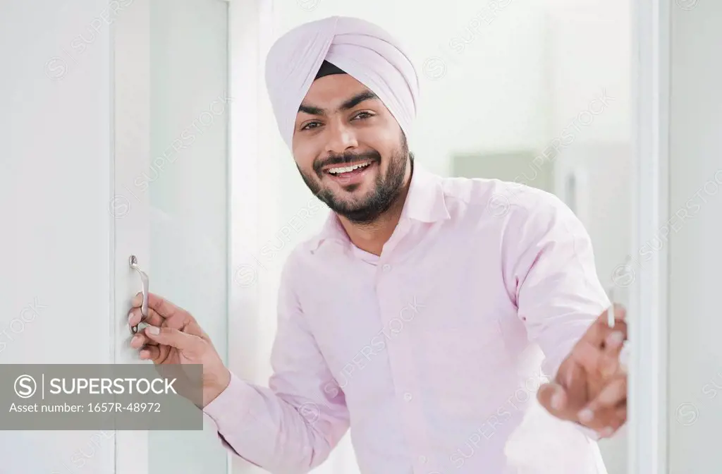 Businessman looking out of a window and smiling