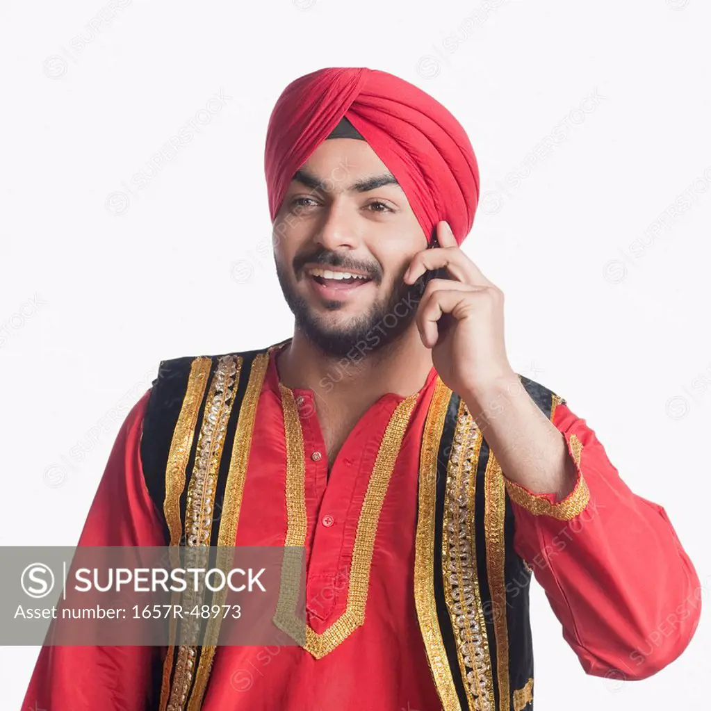 Man in traditional clothing talking on a mobile phone