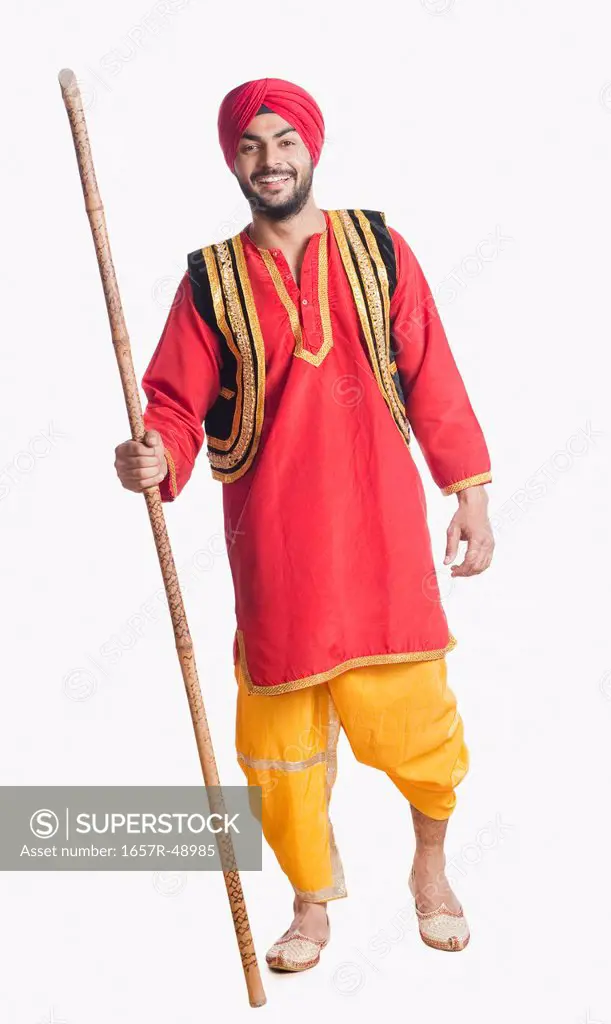Bhangra dancer holding a stick