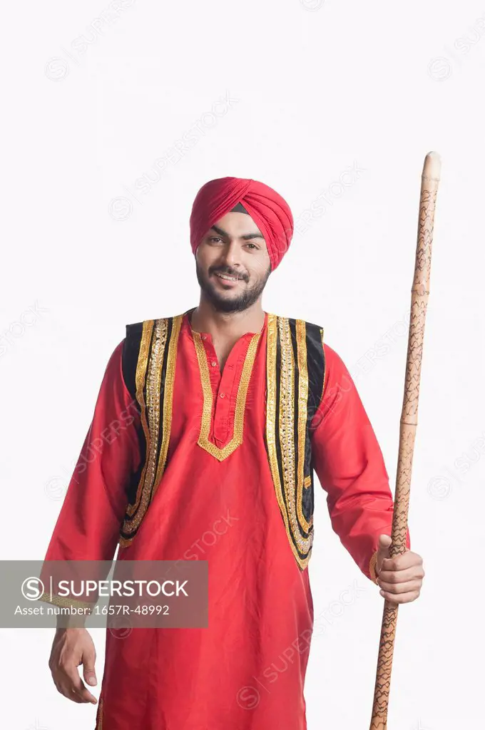 Bhangra dancer holding a stick