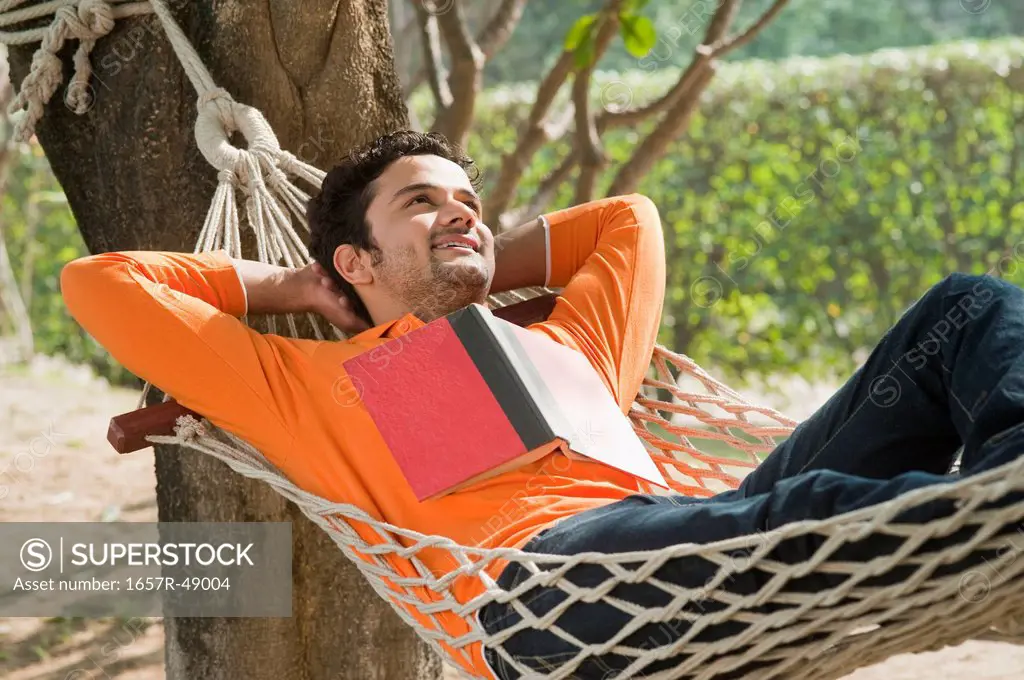 Man day dreaming in a hammock