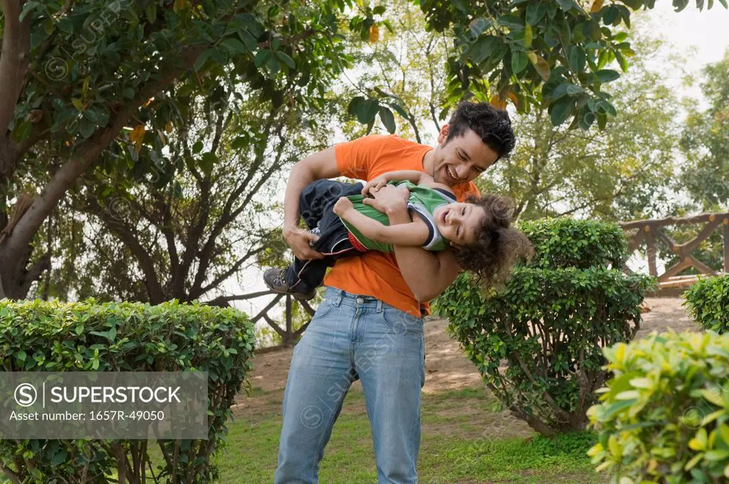 Man enjoying with his son in a garden