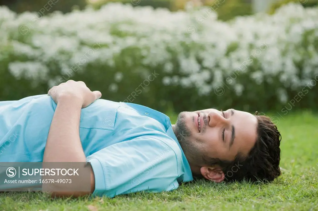 Man lying in a garden and smiling