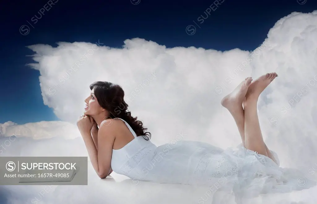 Woman reading a magazine in clouds