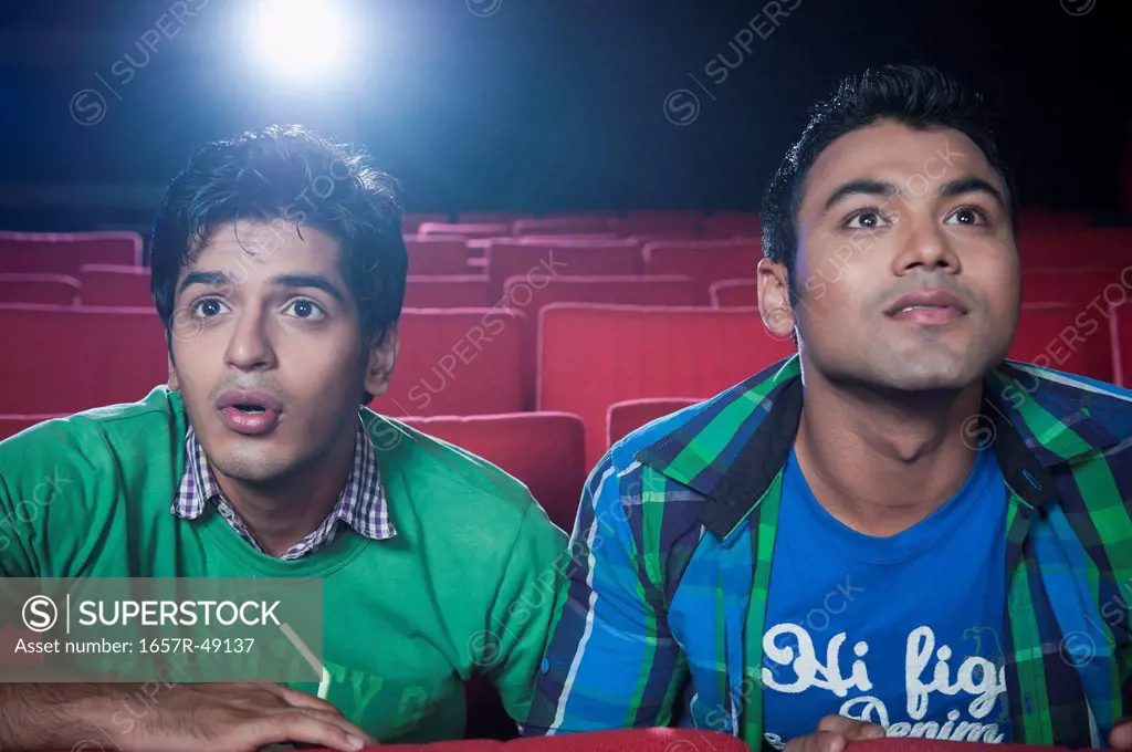Friends enjoying movie in a cinema hall